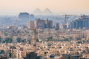 panoramic views of cairo downtown and pyramids at background © jon_chica