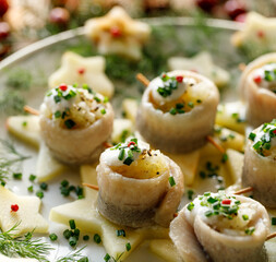 A close-up view of the herring fillet with the addition chopped onions and cream served on...