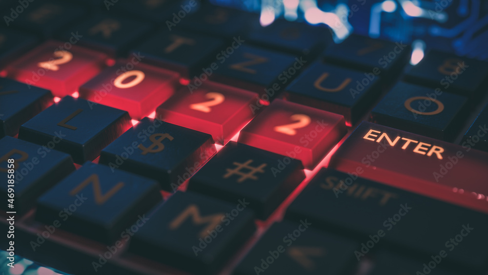 Poster close up view of keyboard with red light on 2022 number keys and enter key. technical concept for en