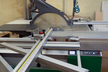 Machine for wood cutting MDF and particle Board or chipboard for the manufacture of details of furniture. Modern automatic woodworking machine.