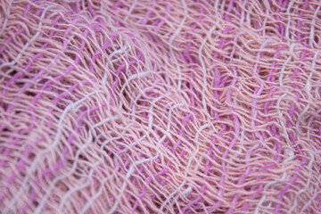 Light Pink Handicraft Clothes on White Background .
Close up Detail of Hand Woven Cotton Scarf ,
Design texture and Pattern by Artisans in Northern Villages of Thailand