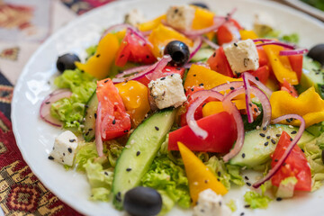 Greek salad dish with feta cheese and olives with vegetables for a healthy meal in a restaurant