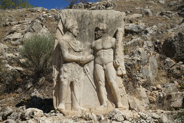 The king Antiochus shakes hand with Herakles (Hercules) in Arsemia ruins. Rock relief statue, Adiyaman province - TURKEY