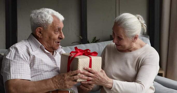 Inspired old age woman wife greet husband with jubilee wish very best to beloved man give special birthday present chosen with care love. Grateful retired male get holiday surprise from dear spouse