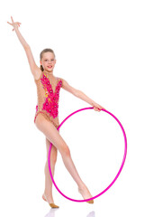 A girl gymnast performs an exercise with a hoop.