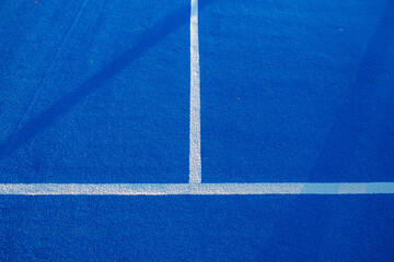 Fototapeta na wymiar Blue paddle tennis court field with white lines. Healthy sports concept