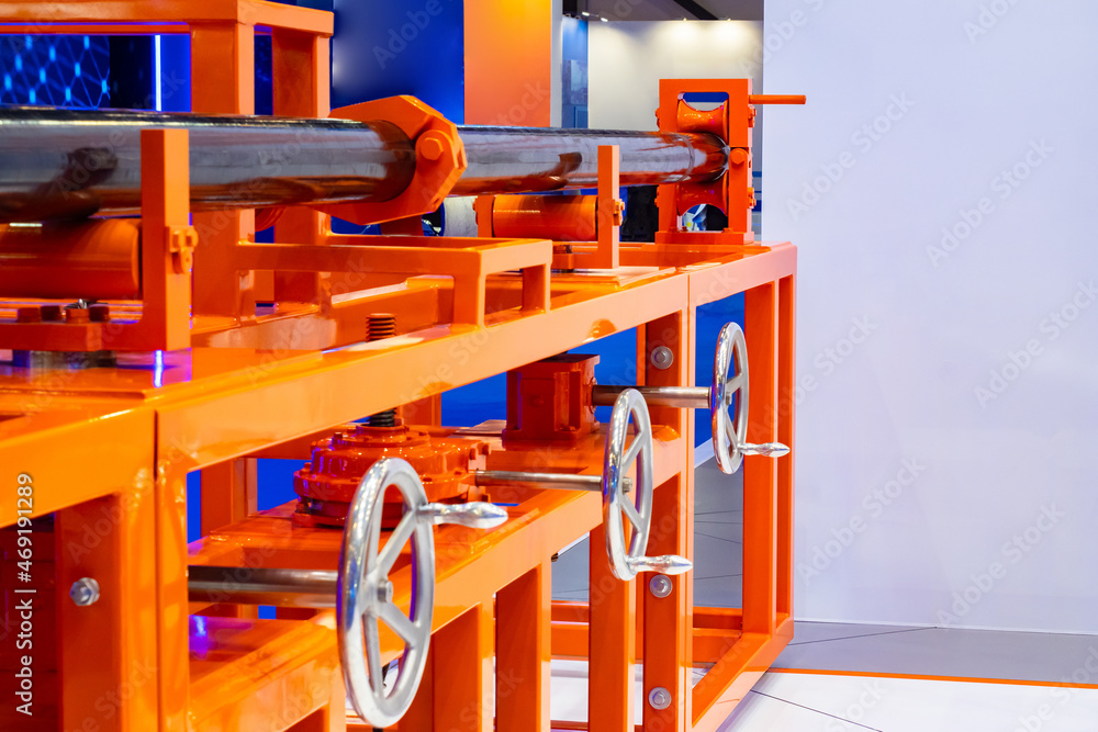 Poster pipe production. production of small diameter pipelines. black pipeline inside rolling vise. vise fo