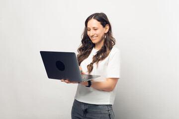 Happy young entrepreneur using laptop over white background.