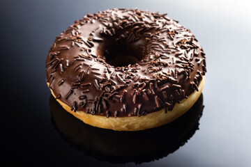 donut with black cream, on a black background, on a mirror, side view, пончик с черным кремом, на черном фоне, на зеркале, вид сбоку