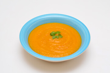 pumpkin puree soup close-up on a white background