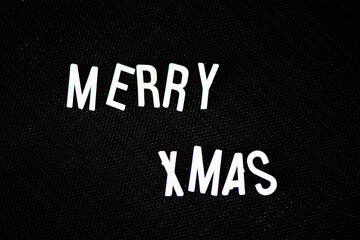 Merry Christmas White Retro 3d letters on a black pin board. 