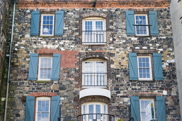 Old weathered and worn wall with windows