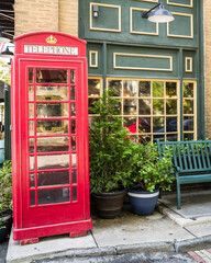 Fototapeta premium Vintage red telephone booth and bench