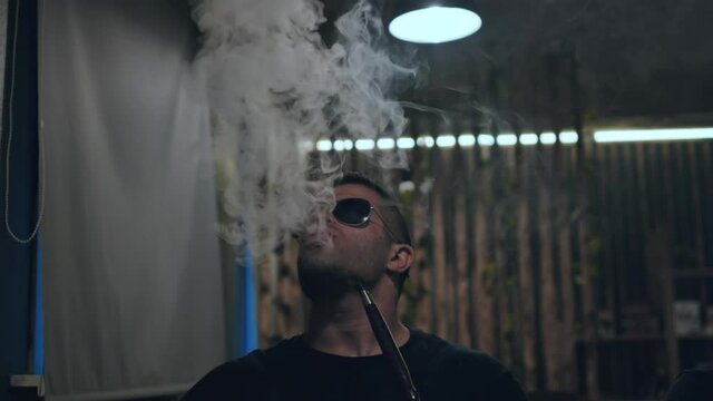 Arabic jordanian young man smokes a hookah.