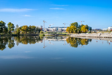 Skolkovo Tsentral'nyy Park pond with reflection of construction site of the Skolkovo Innovation Center