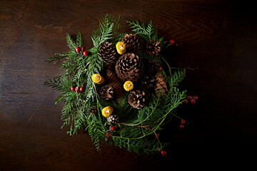Hand crafted rustic Christmas wreath with beeswax candles, cones and evergreen sprigs. Top view - 469198038