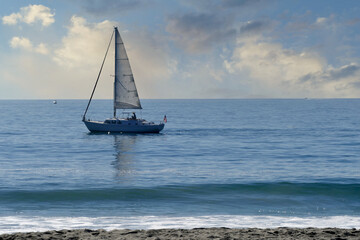 sailboat at sea with gentle breeze and calm water