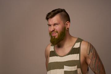 national bearded man in a striped jersey hipster tattoos on his arms