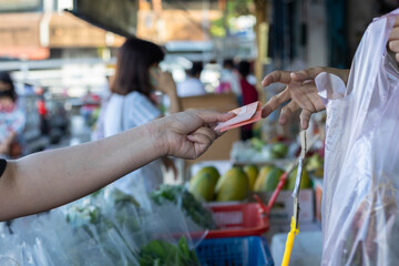 Close-up lady hand paying money in cash Malaysian Note
