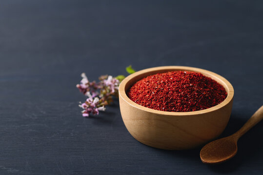 Korean red chili powder in a bowl on black background , Chili flakes