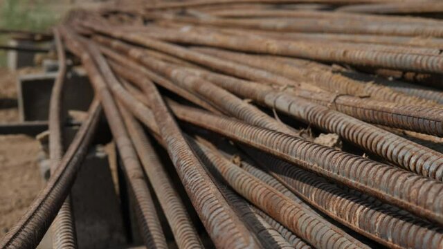 Stack Of Rusty Metal  Reinforcement Rods Laying On Ground. Close Up View