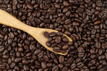 roasted coffee beans with wooden spoon
