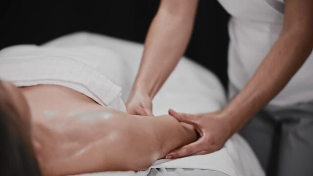 Woman receiving a massage - massaging her hands muscles