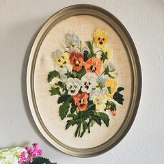 Framed Embroidery on wall with bouquet of flowers
