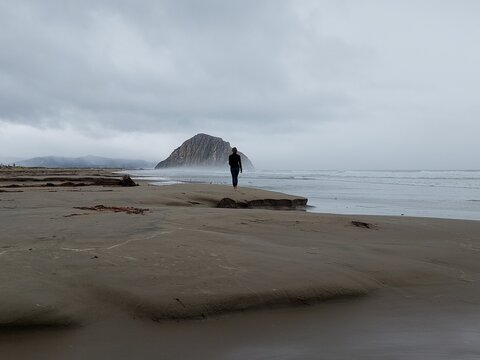 Woman on misty beach
