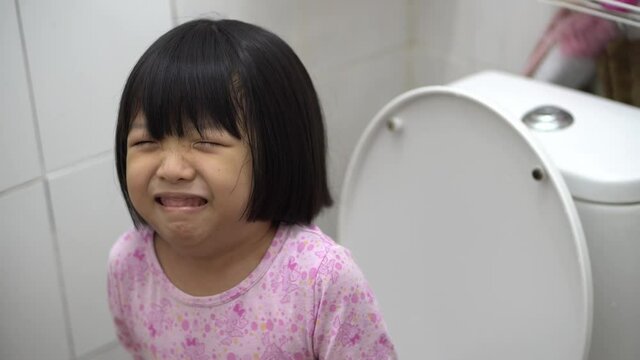 Chinese girl sitting in toilet suffer stomach ache or abdominal pain