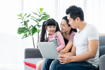 Fototapeta premium Happy asian family playing together at home in living room
