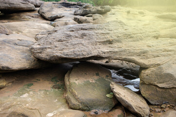 Background image of rocks eroded by river water, grooves and holes. Light fare.