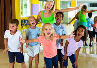 Positive children in dance studio smiling and having fun. High quality photo