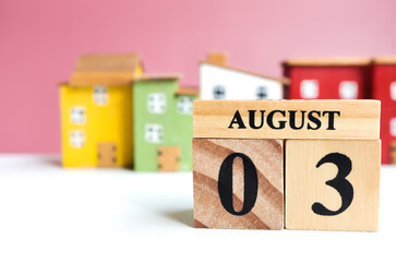 August 3, Cube wooden calendar showing date on 3 August. Wooden calendar with date on the table. blur objects on background
