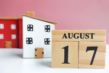 Hello August, Cube wooden calendar showing date on 17 August. Wooden calendar with date on a light background.