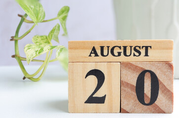 Hello August, Cube wooden calendar showing date on 20 August. Wooden calendar with date on a light...