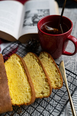 Yellow bread, cup of tea and a book
