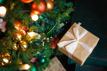 Christmas tree with wooden rustic decorations and presents under it in loft interior.