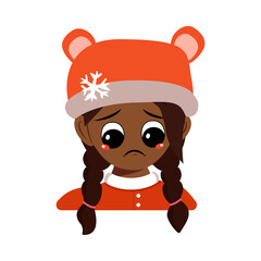 Girl of African American or Latin nationality with sad emotions, depressed face, down eyes in bear hat with snowflake. Cute baby melancholy expression in winter headdress. Head of adorable child