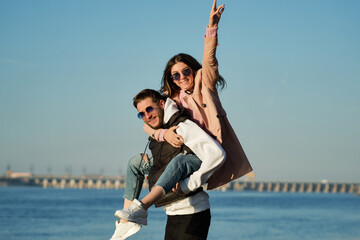 Carefree young couple Tourists travelers enjoy vacation by sea beach. Lovely hipster lovers having fun together outdoors. Concept of youth, love and lifestyle. Freeluft aesthetics. Casual style