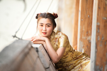 Chinese woman  dress traditional cheongsam ,close up portrait in chinese temple  in China Town for Chinese new year concept.