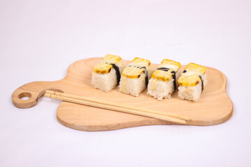 delicious sushi and a pair of chopsticks isolated on white background
