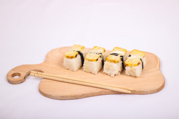 delicious sushi and a pair of chopsticks isolated on white background