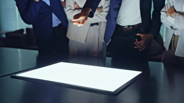 Group of multi racial people watching light screen in the night office. Global business. Teamwork of business. Diversity.