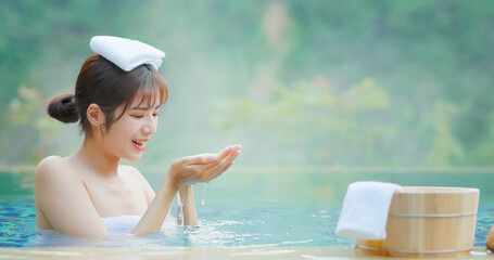 Woman scoop up hot spring