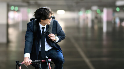 Asian businessman going to work with bicycle. Eco Transportation and healthy active lifestyle concept.