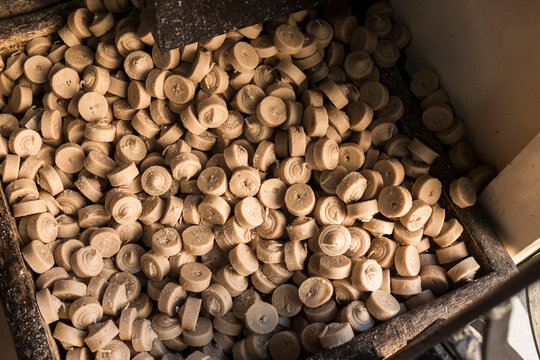A supply of mocha colored prayer candles at a chapel.