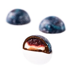 Handmade chocolate candies with filling isolated on a white background.