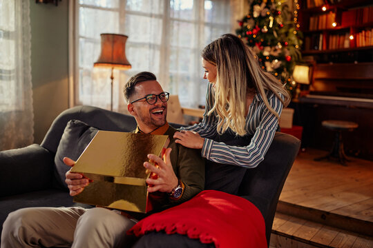 Man Receiving A Christmas Gift From Is Girlfriend