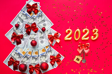 Christmas tree made of 100 dollar bills and House key, candles with the numbers 2023. Christmas...